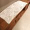 Medium tablecloth in white knitted with crochet, geometrical patterns. Dimensions 40 x 1,00m.