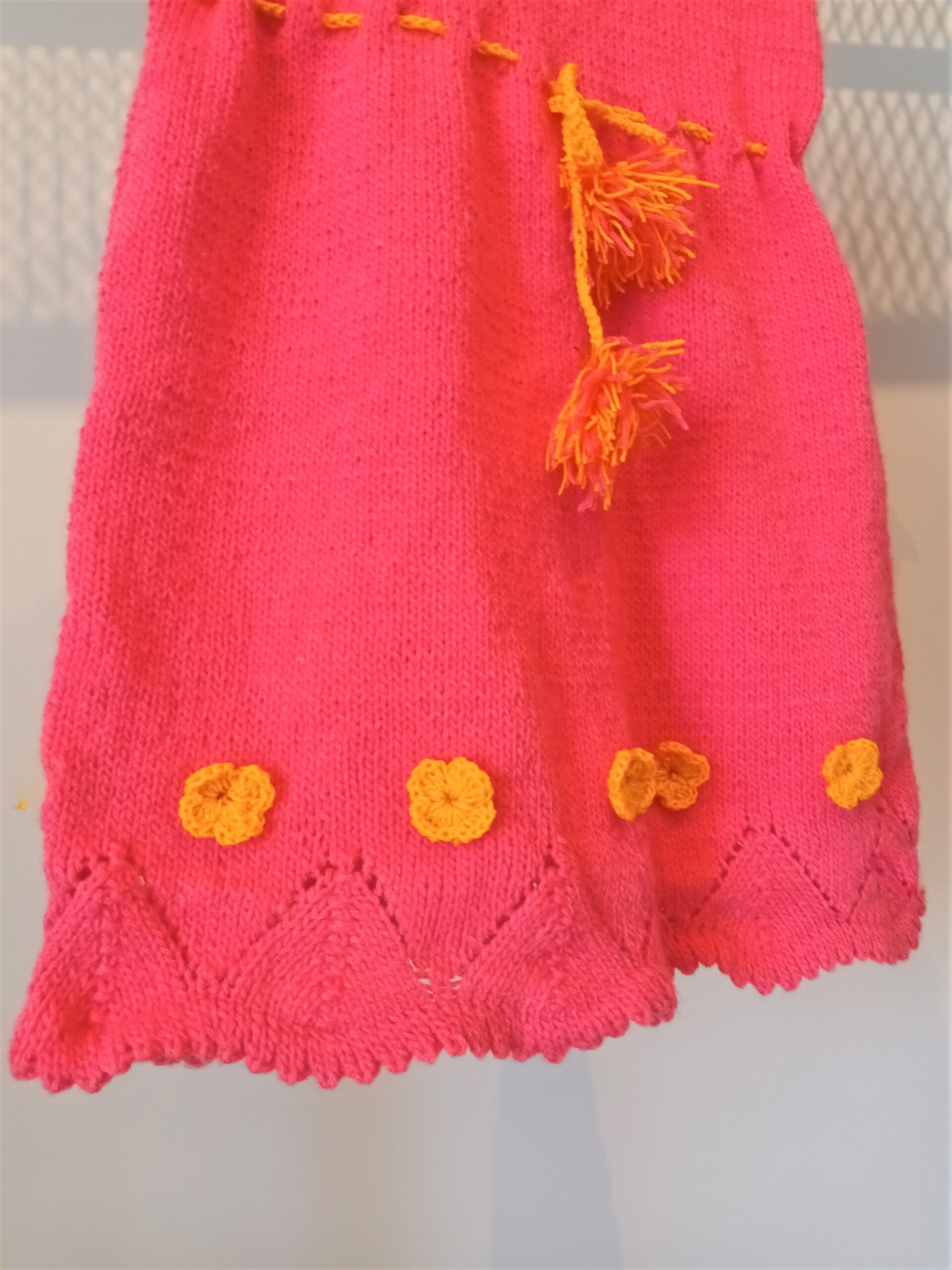 Handmade baby dress with crochet in magenta with orange details