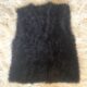 Handmade warm baby jacket without sleeves, in black, in a flufy yarn that makes it a unique piece for your baby's wardrobe.