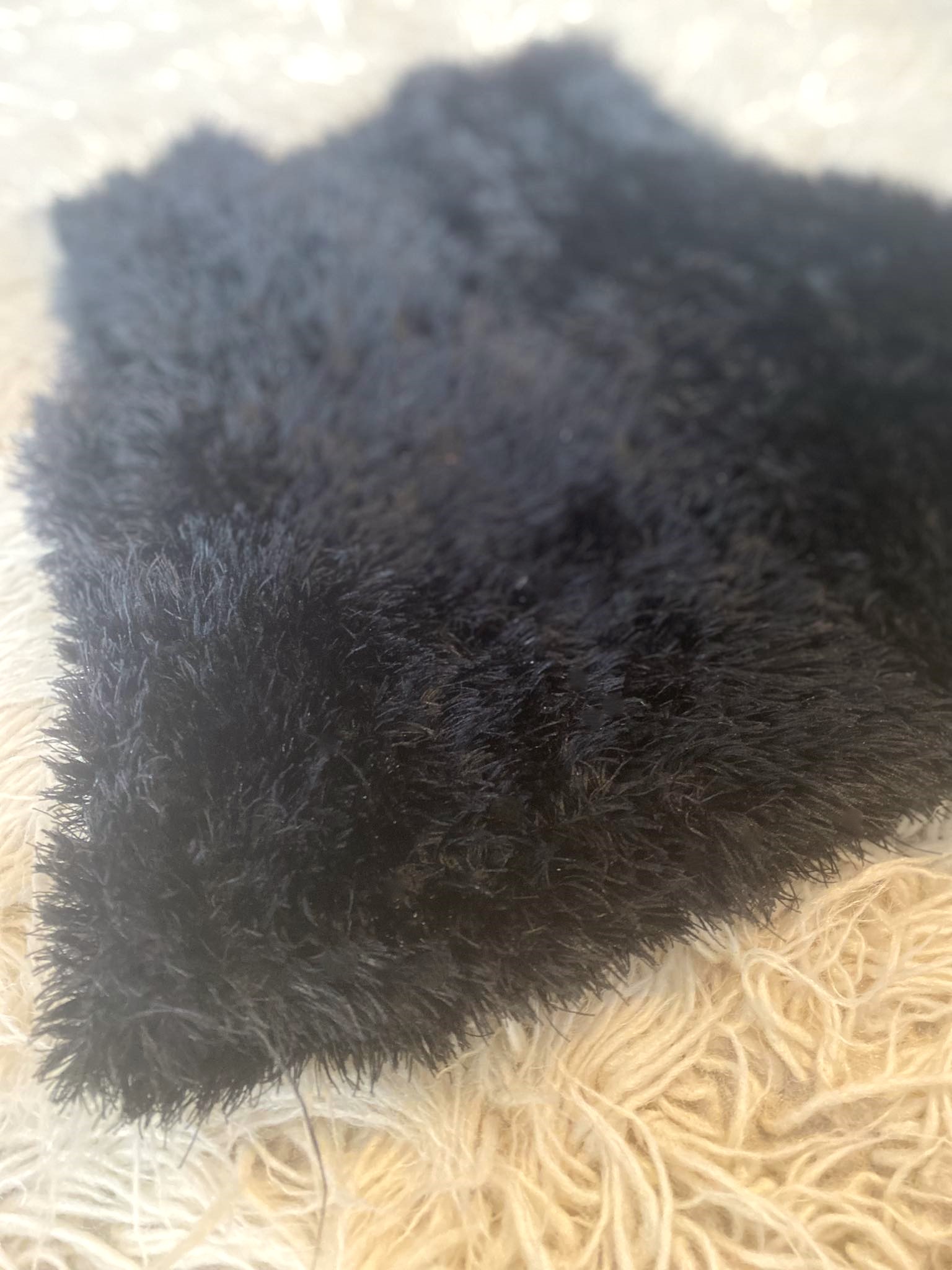 Handmade warm baby jacket without sleeves, in black, in a flufy yarn that makes it a unique piece for your baby's wardrobe.